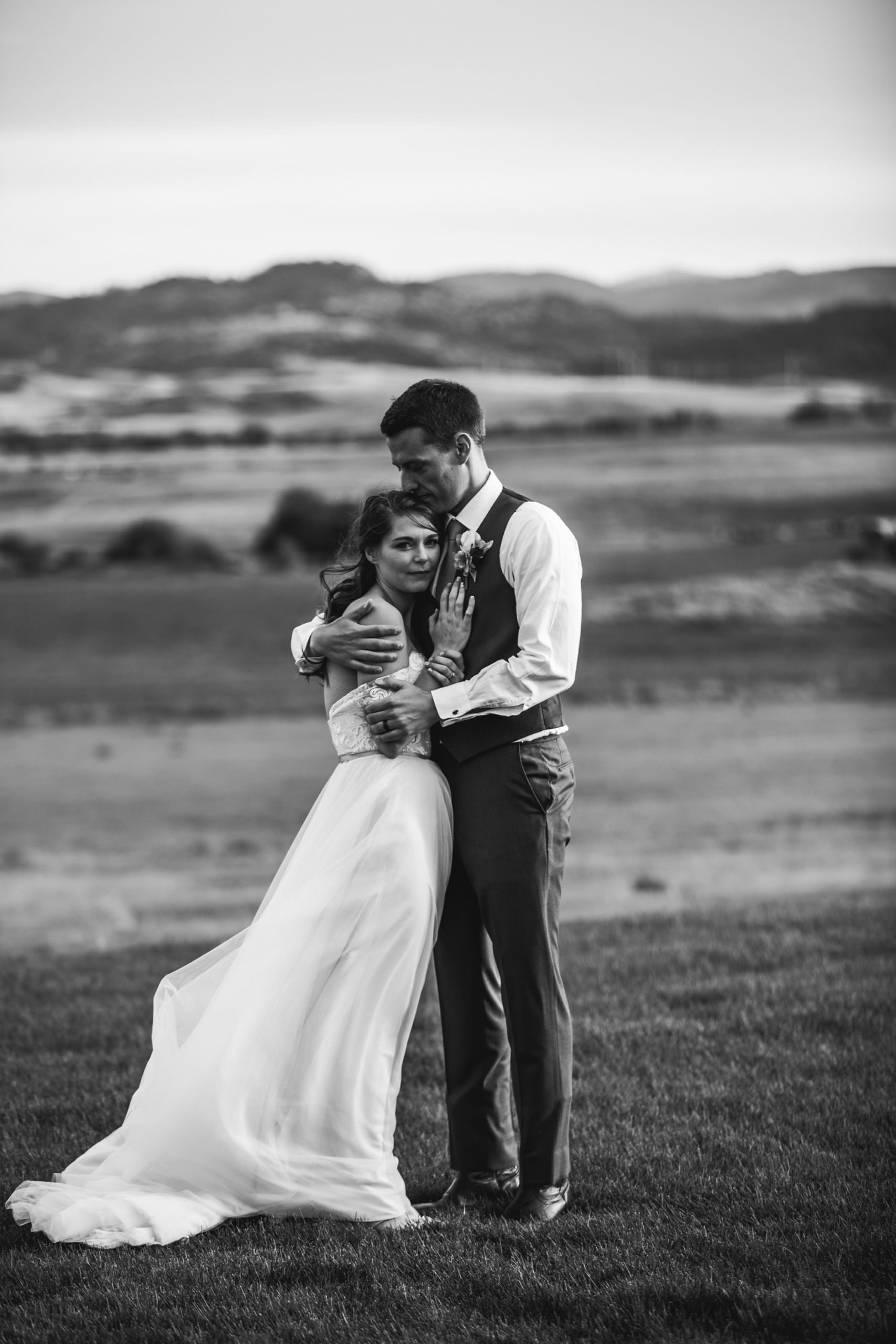 Bride groom hugging in wind, south dakota