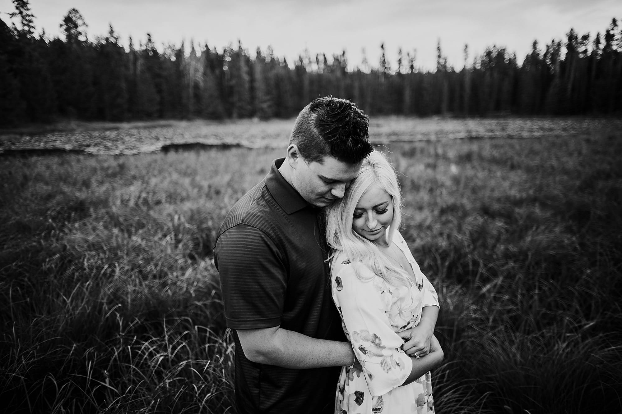 engagement couple in grass in wyoming