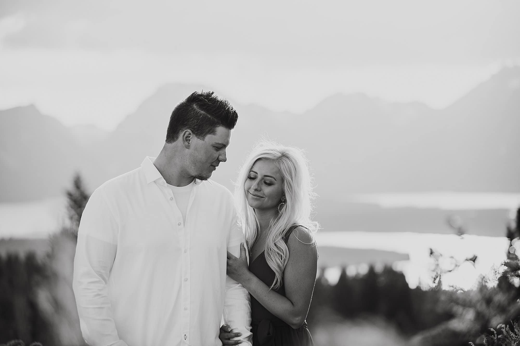 sunset photo of couple during engagement session, tetons in background