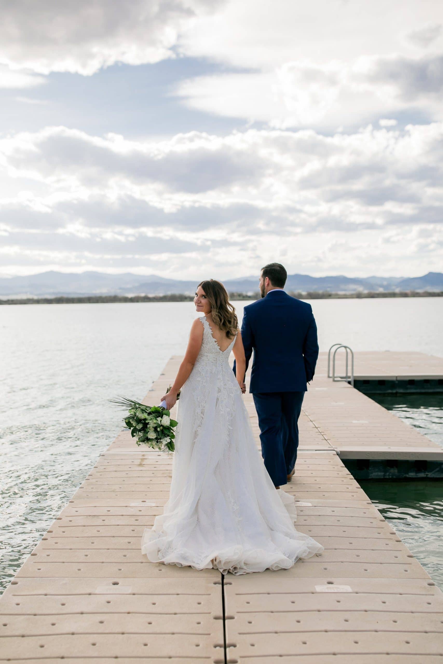 Colorado Wyoming wedding on lake, bride and groom on boat dock