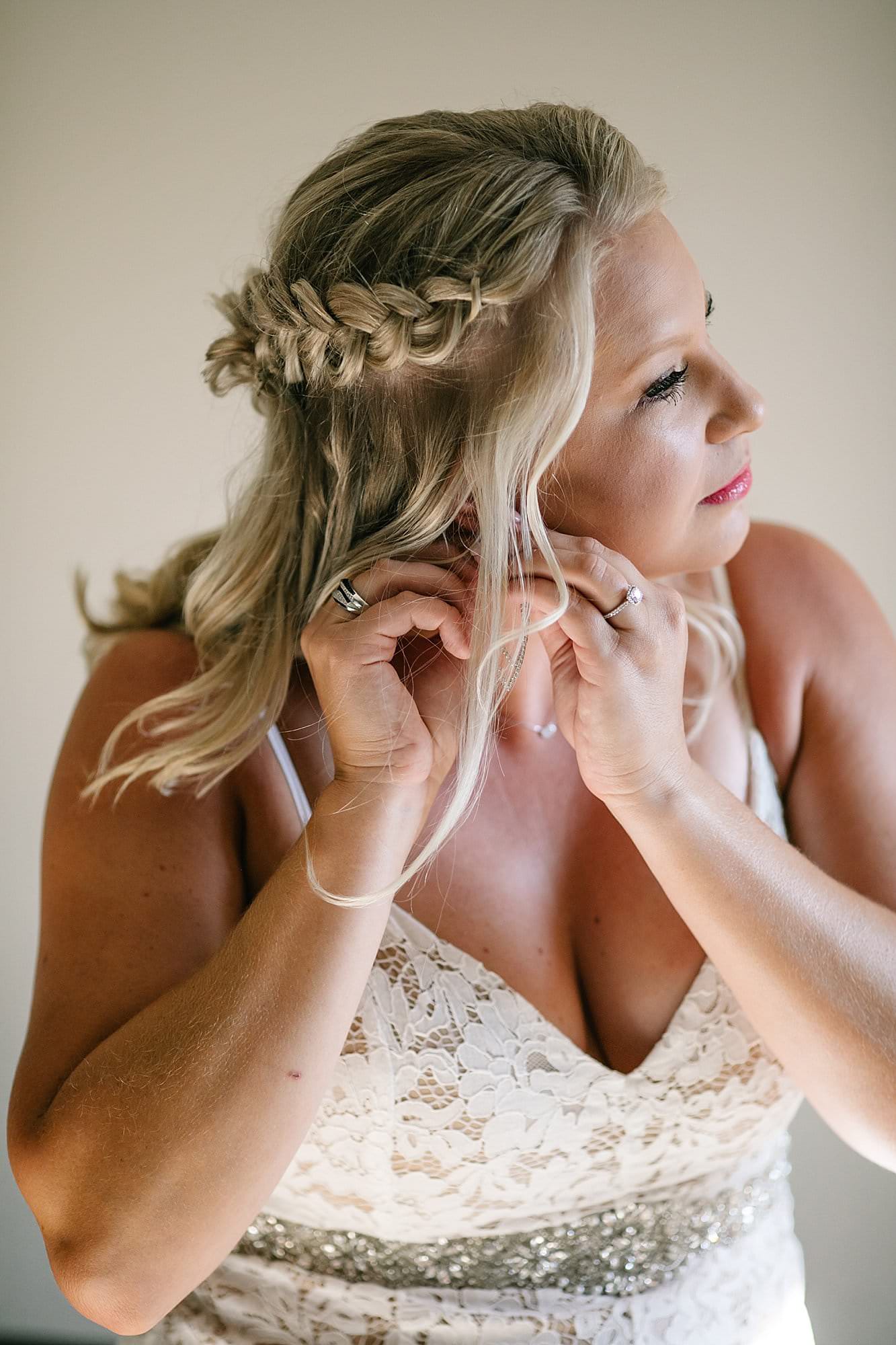 bride putting earring on