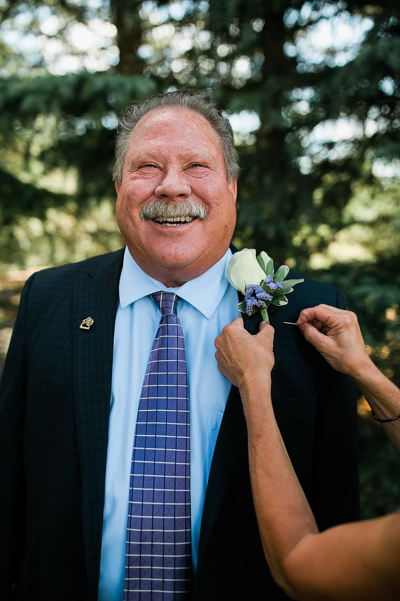 dad of bride getting flower