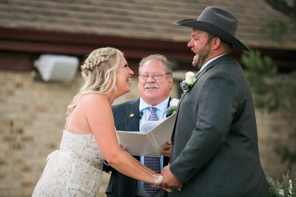 bride and groom laughing during ceremony