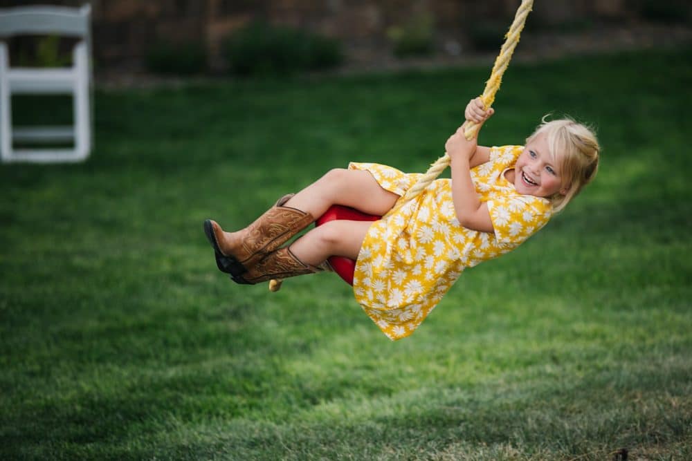 girl swinging at wedding