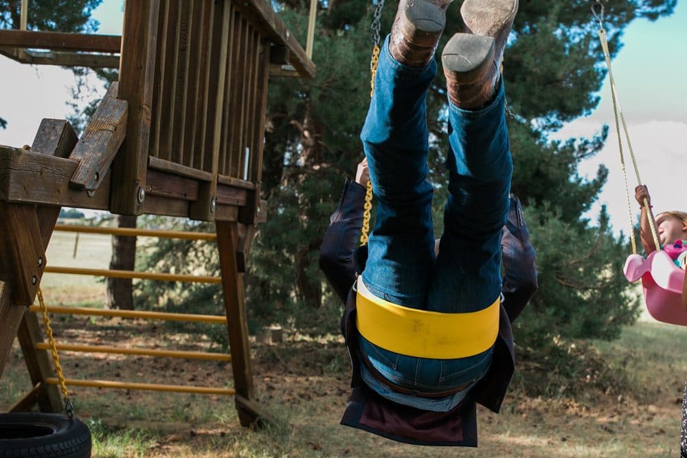 adult swinging at wedding