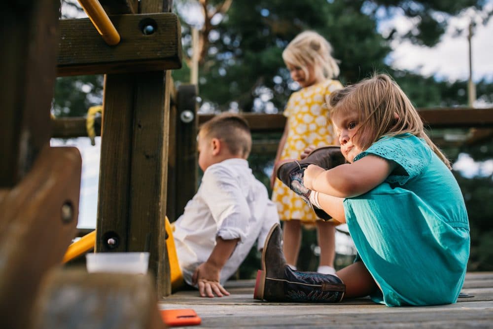 toddler struggling with boot