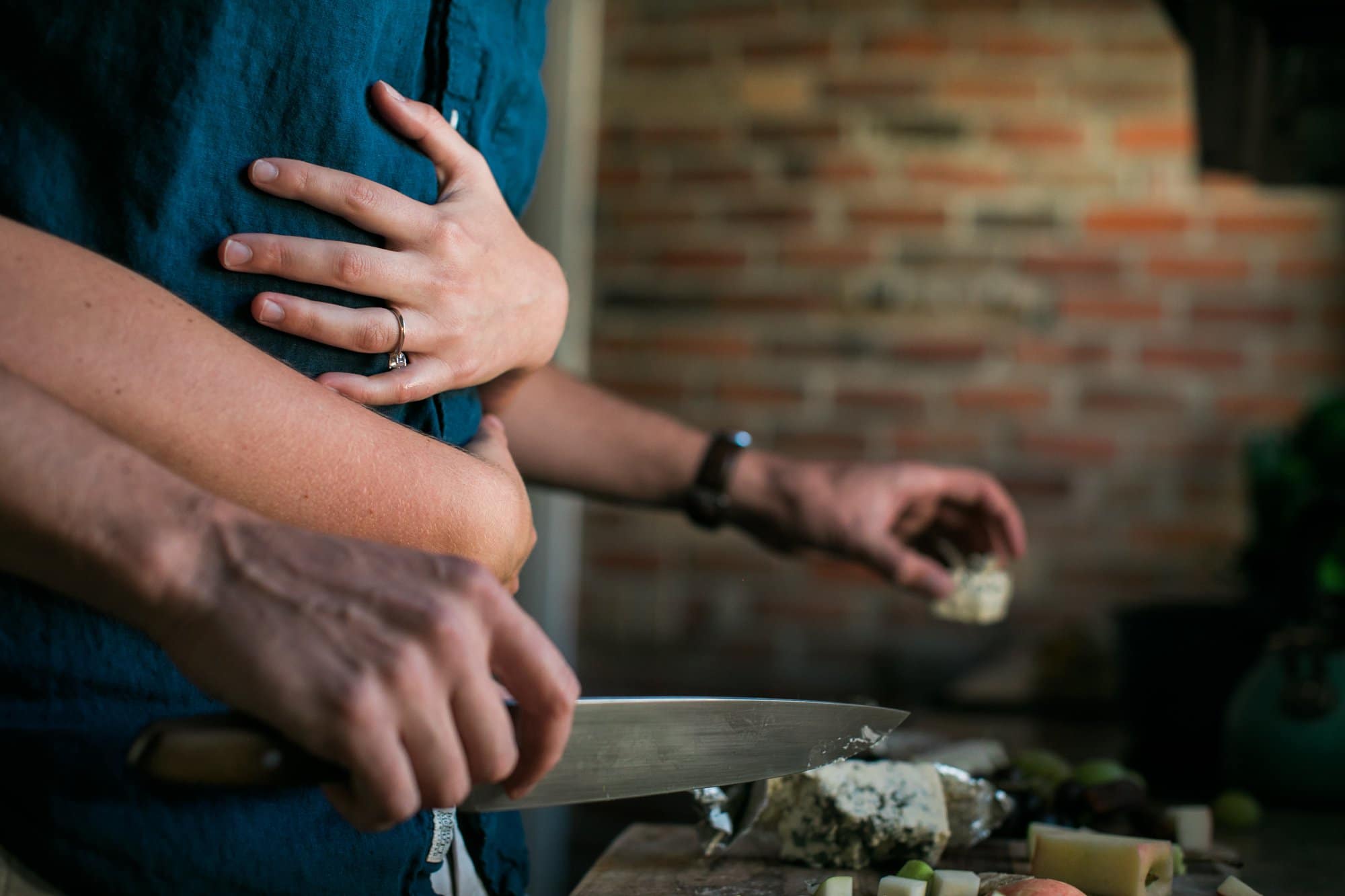 couple cooking at home for engagement in colorado